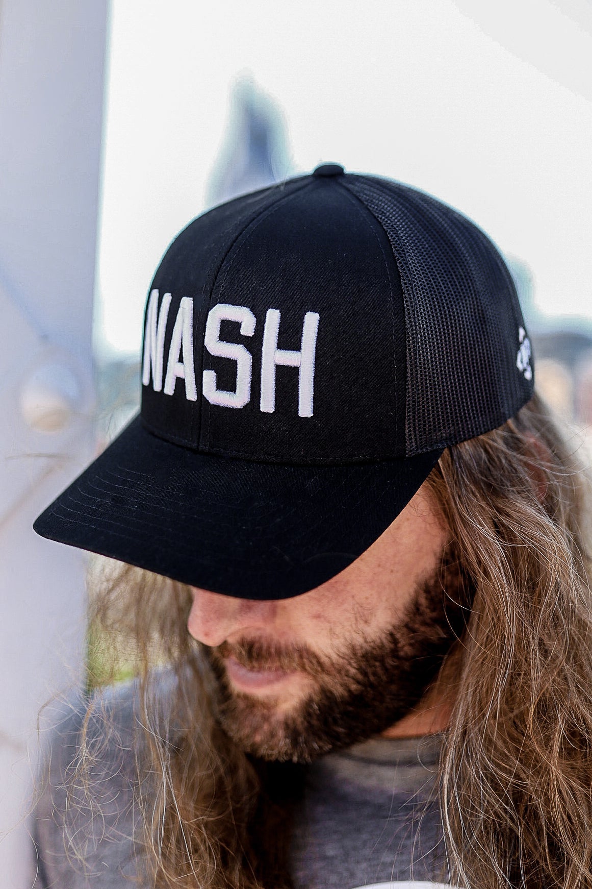 Model wearing the classic NASH trucker in black