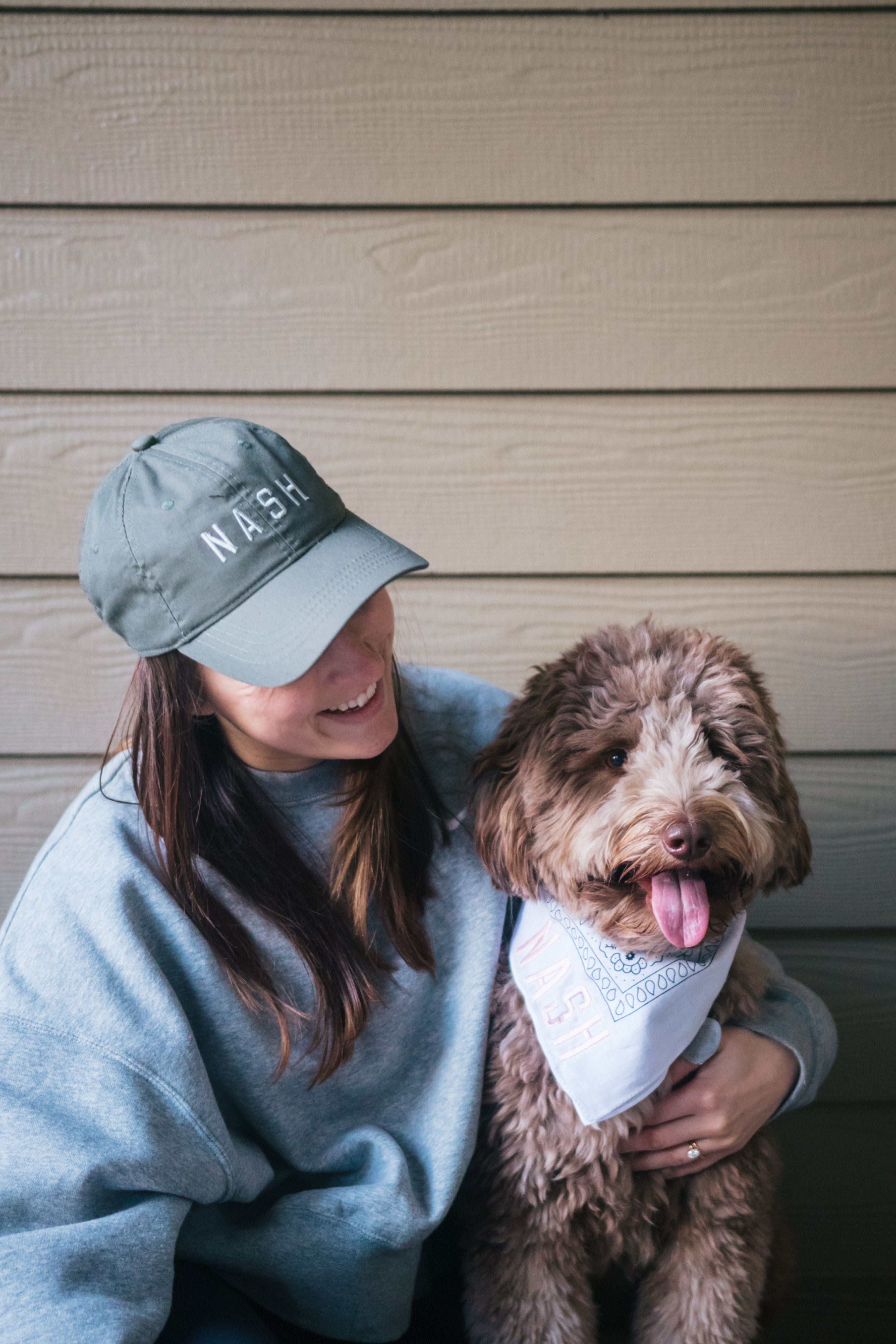 Dog mom wearing nash hat to match dog in bandana 